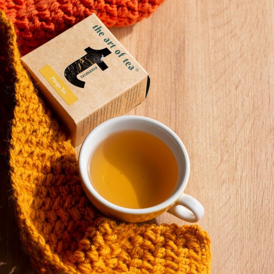 mango black tea and cup and tea box