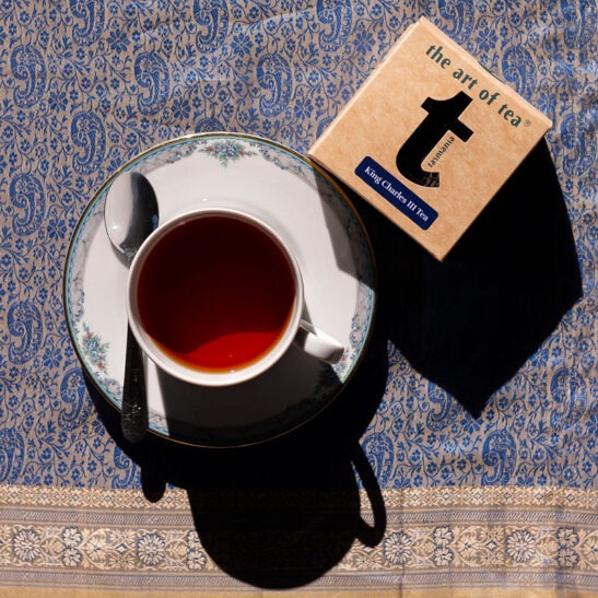 King Charles III lblack tea leaves with tea cup and tea box