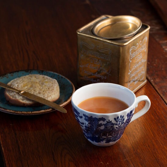 English Breakfast black tea with cup and old tea caddy